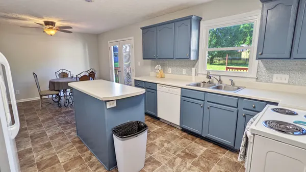 a kitchen with a sink stove and cabinets