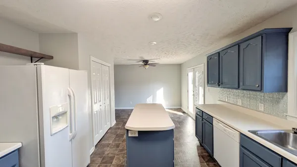 a bedroom with a bed and ceiling fan