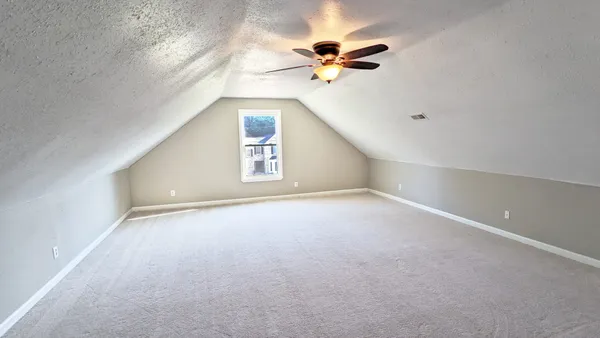 a balcony with wooden floor and trees in the background