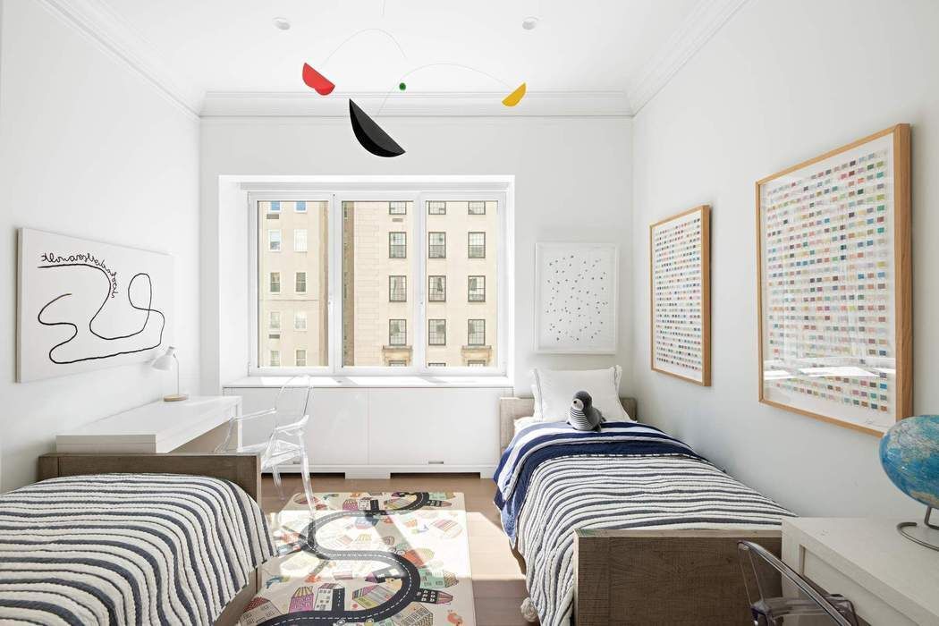 910 5th Avenue, Unit 7C Manhattan, NY 10021 - Photo 10 of 15 a bedroom with a bed and wooden floor