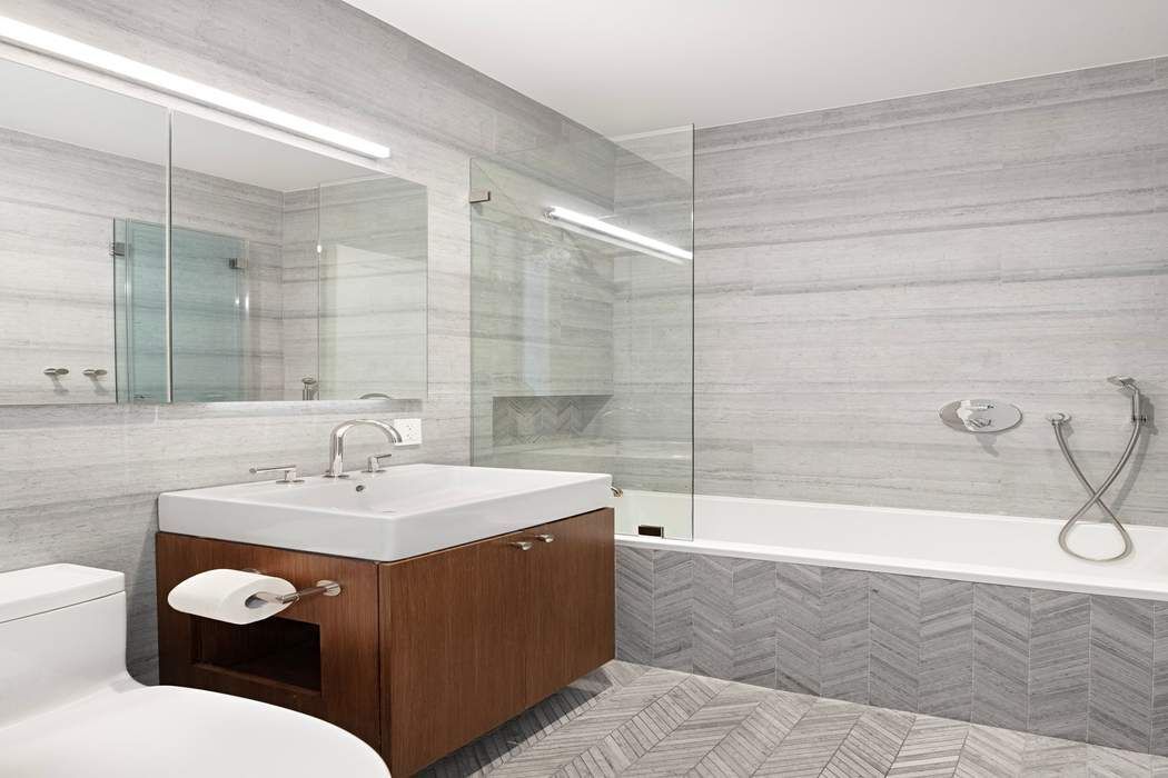 910 5th Avenue, Unit 7C Manhattan, NY 10021 - Photo 11 of 15 a bathroom with a sink mirror toilet and bathtub