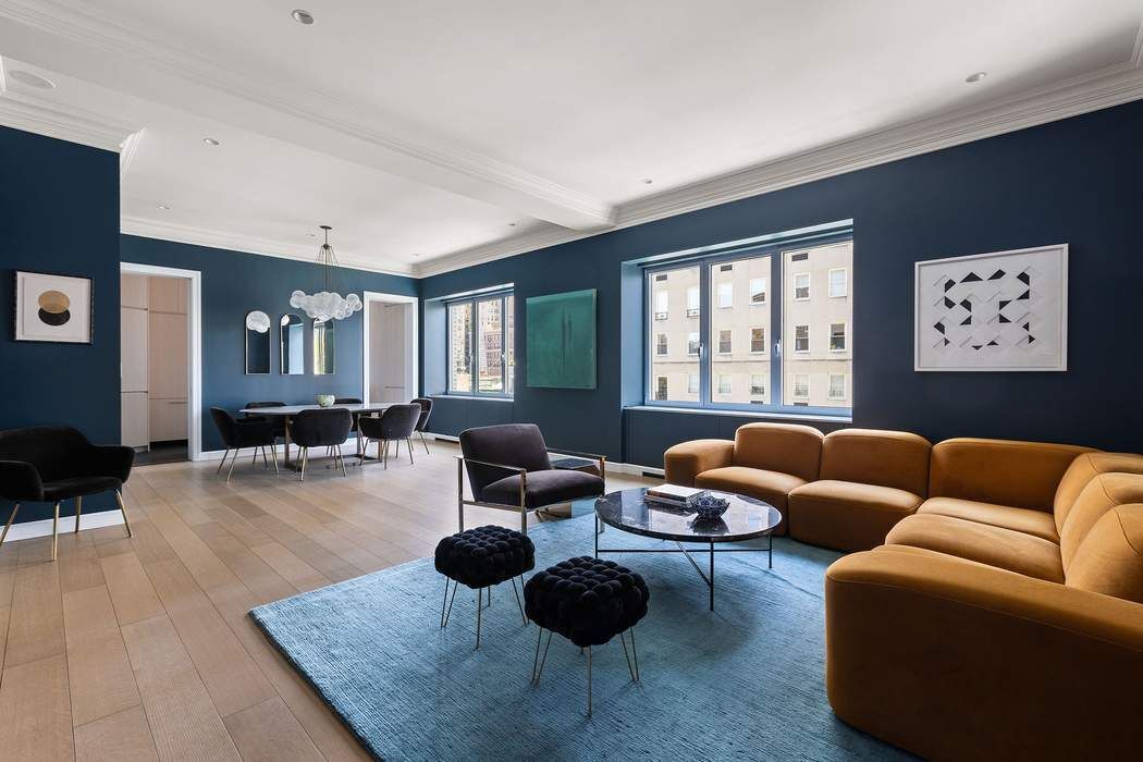 910 5th Avenue, Unit 7C Manhattan, NY 10021 - Photo 4 of 15 a living room with furniture a rug and a large window