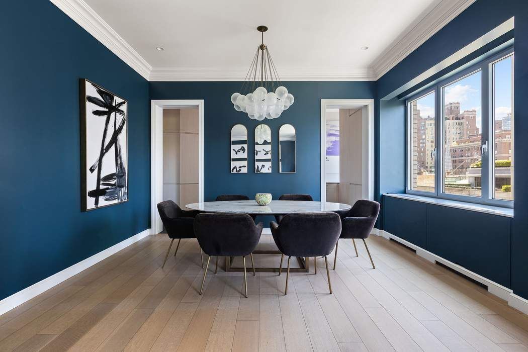 910 5th Avenue, Unit 7C Manhattan, NY 10021 - Photo 5 of 15 a dining room with wooden floor a chandelier a wooden table and chairs