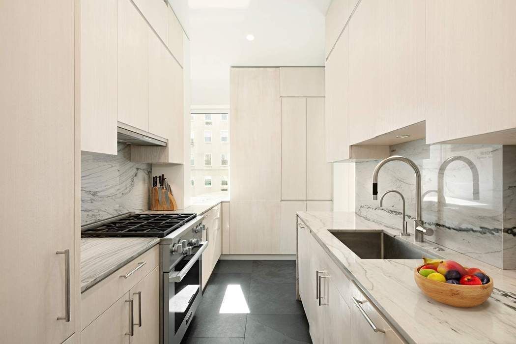 910 5th Avenue, Unit 7C Manhattan, NY 10021 - Photo 6 of 15 a kitchen that has a sink and a stove
