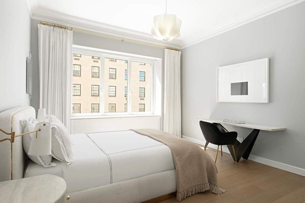 910 5th Avenue, Unit 7C Manhattan, NY 10021 - Photo 7 of 15 a bedroom with a bed and a window