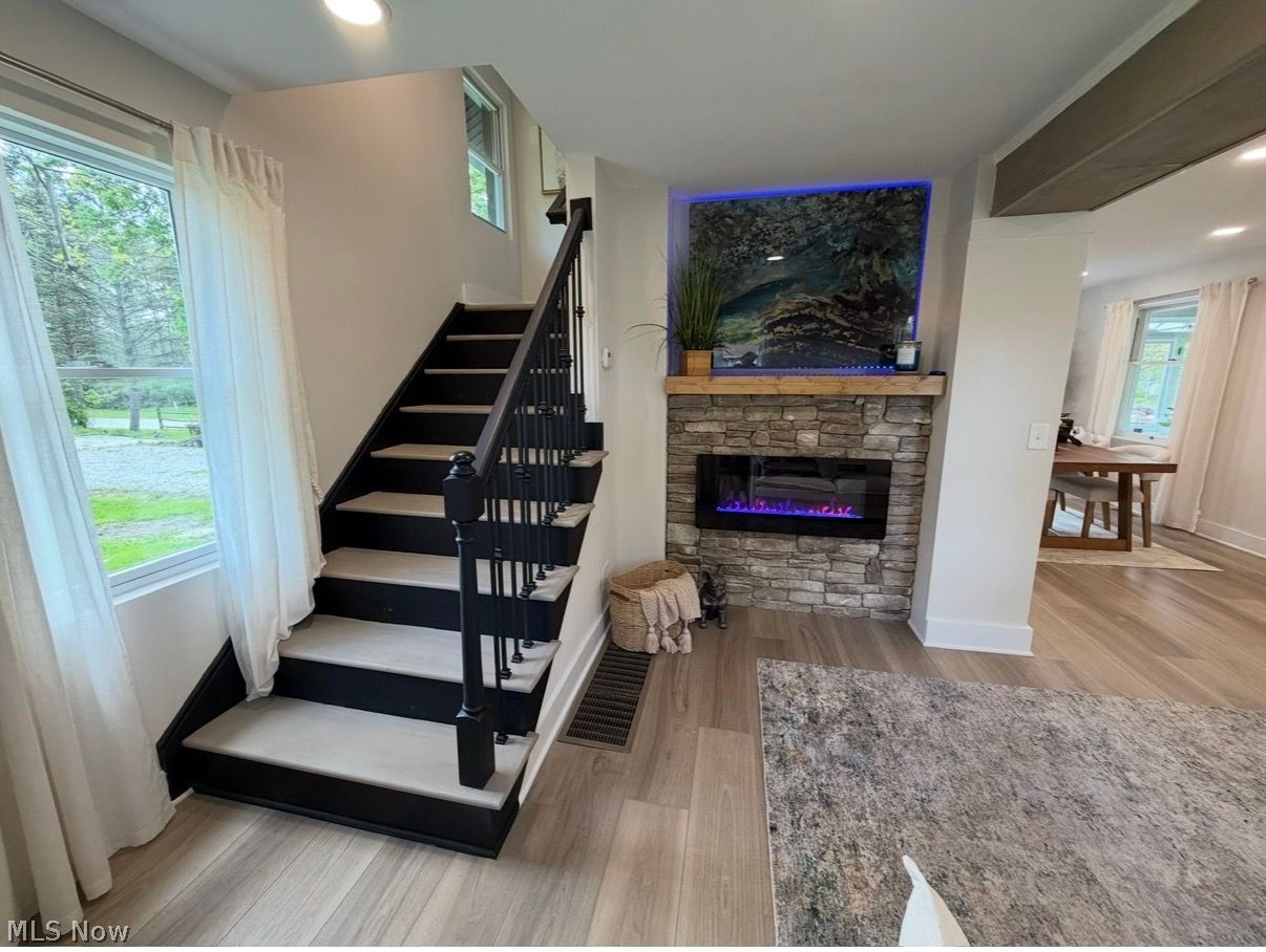 5366 Barton Road North Ridgeville, OH 44039 - Photo 13 of 49 Living Room with electric fireplace, stone mantel, and recessed lighting.