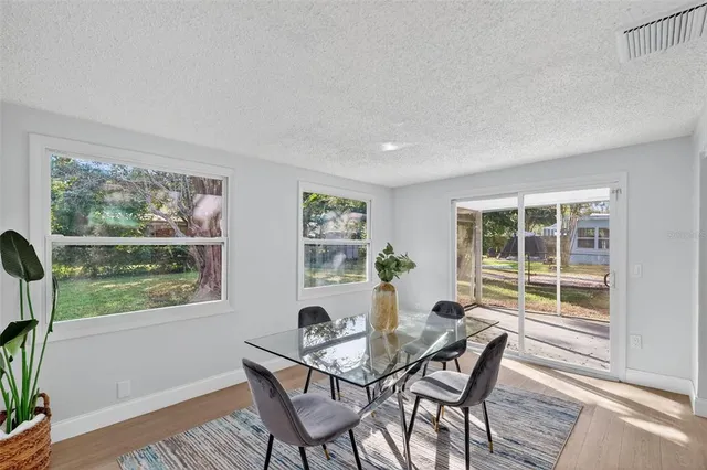 a view of a dining room with a table and chairs