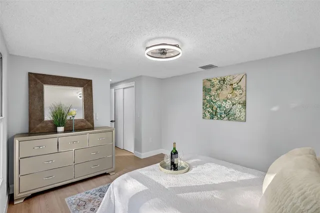 a bedroom with a bed and a dresser