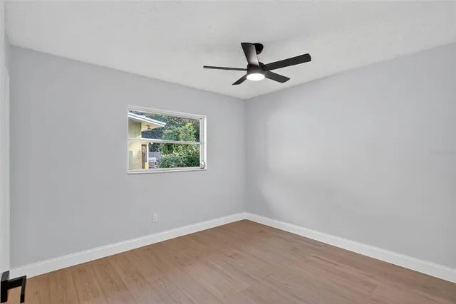 a view of a livingroom with a ceiling fan and wooden floor