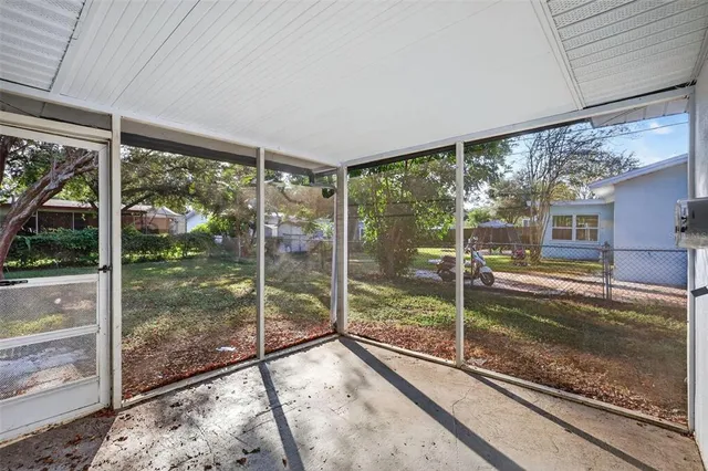 a view of a hallway with a glass door and furniture