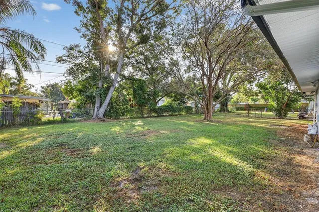 a view of a house with a backyard