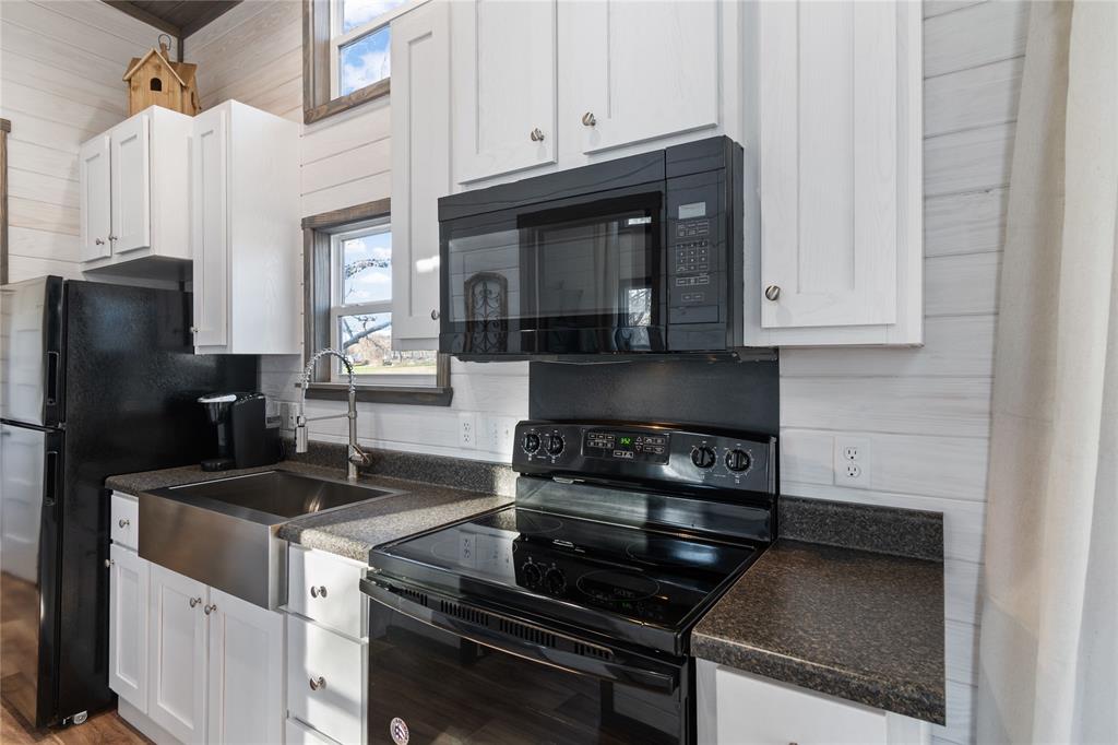 6801 Fm 1616 Athens, TX 75752 - Photo 19 of 28 a kitchen with granite countertop a stove and a refrigerator