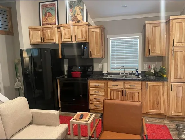 a view of a hallway with wooden floor and dining room