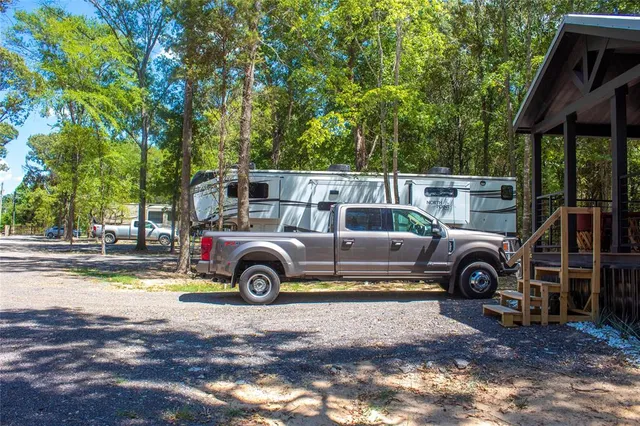 a view of a patio with a table and chairs under an umbrella