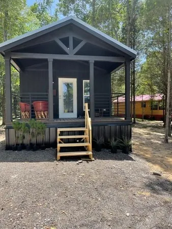 a view of an empty room with a window and closet area