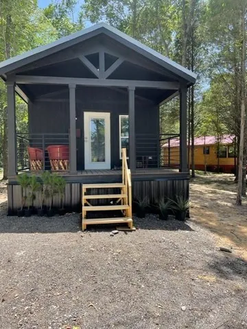 a view of an empty room with a window and closet area