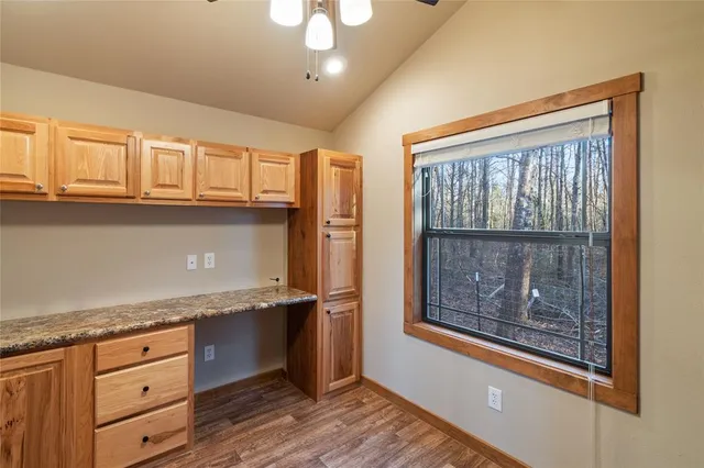 a kitchen with granite countertop a sink and a stove top oven