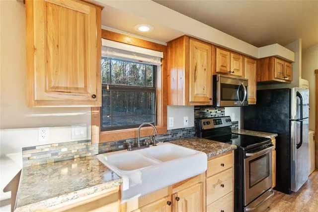 a kitchen with stainless steel appliances granite countertop a stove and a sink