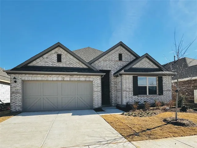 a front view of a house with yard