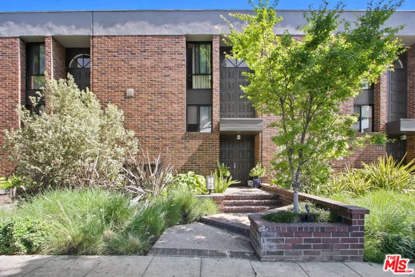 front view of a house with potted plants