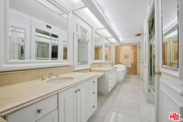 a spacious bathroom with a granite countertop sink mirror and a shower