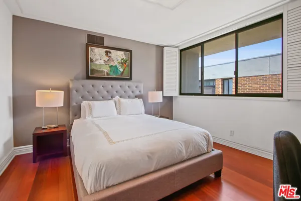 a bedroom with a bed and a night stand