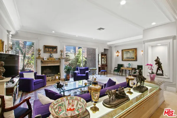 a living room with fireplace furniture and a flat screen tv