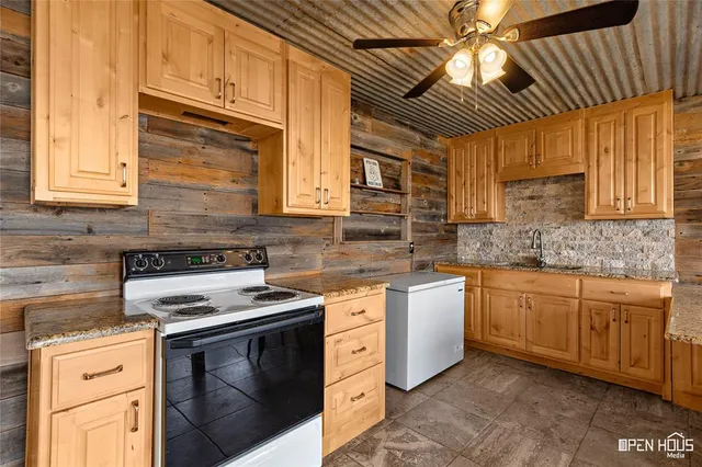 a kitchen with stainless steel appliances granite countertop a stove sink and cabinets