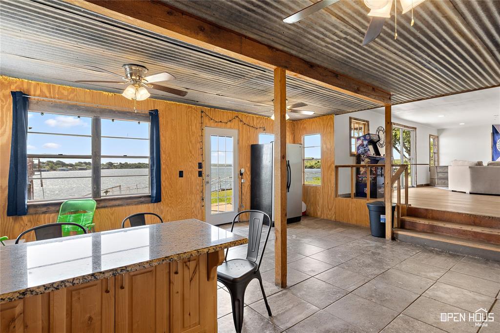 894 West Moonshine Road Seymour, TX 76380 - Photo 15 of 23 a view of a porch with chairs and floor to ceiling window with wooden floor