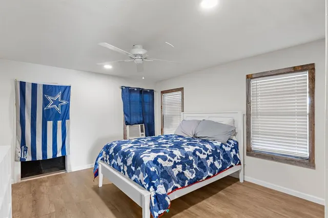 a bedroom with a large bed and a chandelier