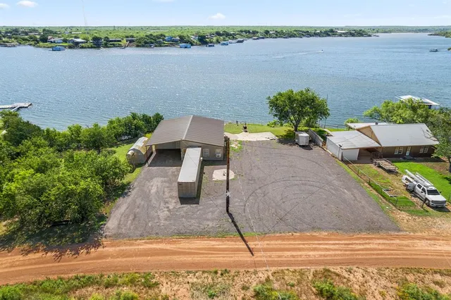 a view of a lake with couches and table and chairs