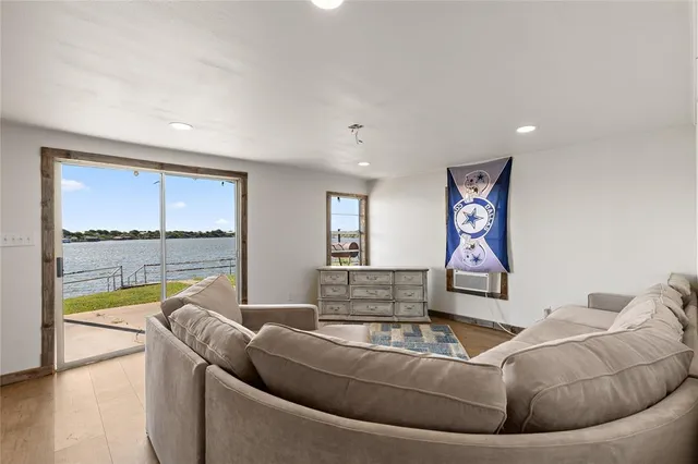 a living room with furniture and a floor to ceiling window