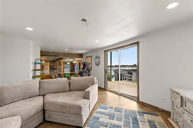 a living room with furniture and a glass door