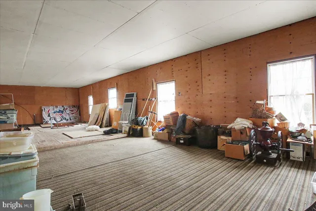 a bedroom with furniture and a large window