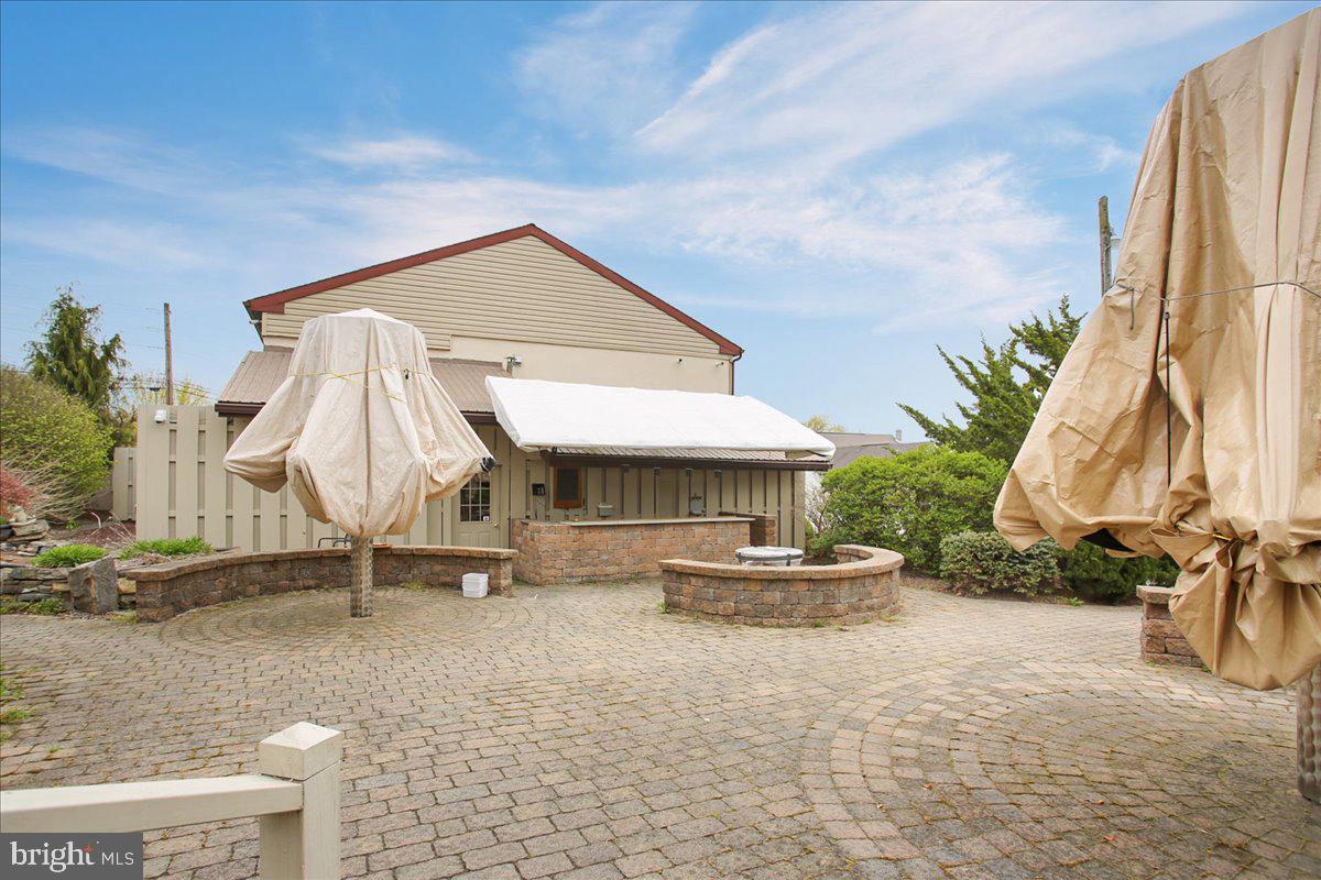 4 Baldy Hill Road Boyertown, PA 19512 - Photo 40 of 51 a backyard of a house with barbeque oven table and chairs