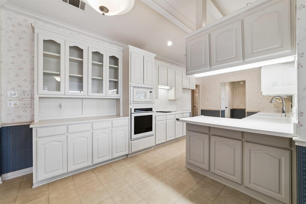 1175 Bloom Street Lucas, TX 75002 - Photo 13 of 36 a kitchen with granite countertop white cabinets and white appliances