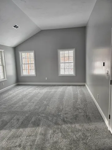a view of an empty room and closet area