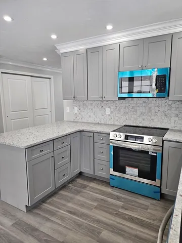 a kitchen with stainless steel appliances granite countertop a stove and a sink