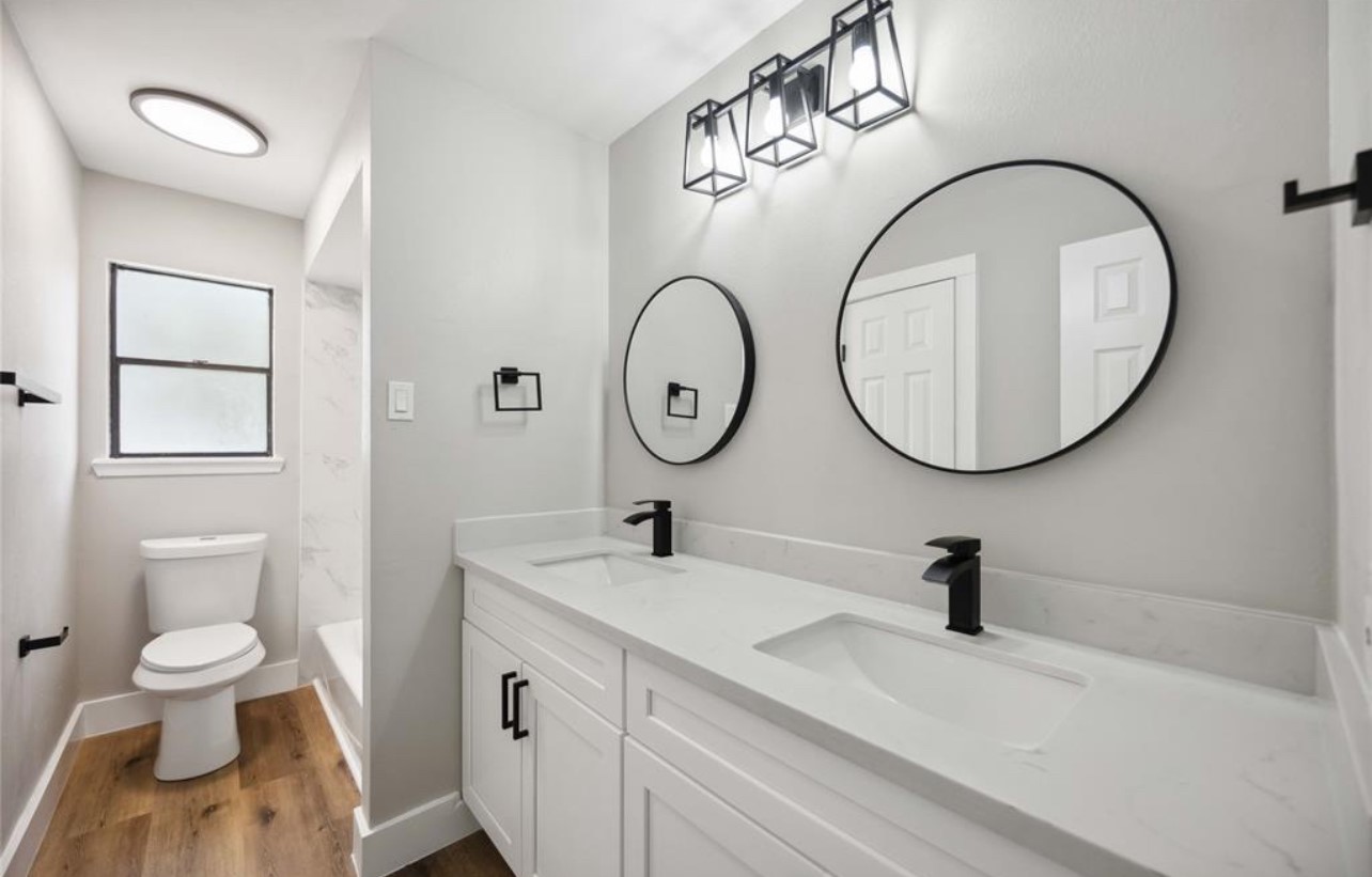 8143 Northbridge Drive Spring, TX 77379 - Photo 20 of 30 a bathroom with a toilet a sink and a mirror