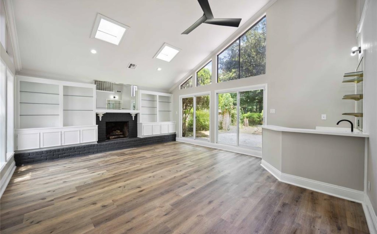8143 Northbridge Drive Spring, TX 77379 - Photo 2 of 30 a view of empty room with wooden floor and fireplace