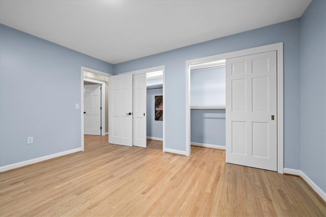 103 Satula Lane Clemson, SC 29631 - Photo 26 of 50 This airy bedroom features gleaming hardwood floors and ample closet space, providing a versatile living area.