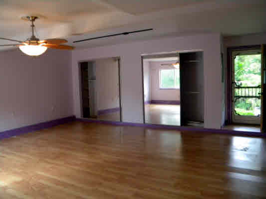 6392 Kalama Road, Unit 4 Kapaa, HI 96746 - Photo 22 of 24 a view of an empty room with wooden floor and a window