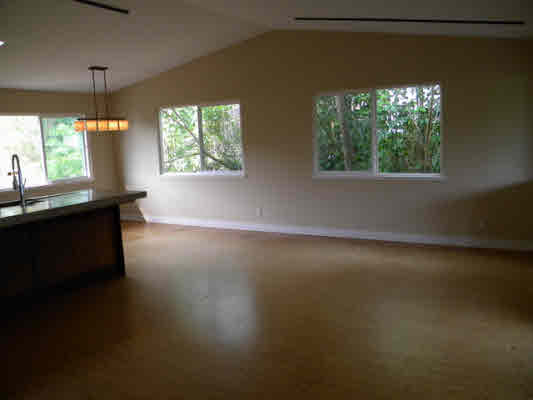 6392 Kalama Road, Unit 4 Kapaa, HI 96746 - Photo 9 of 24 an empty room with wooden floor and windows
