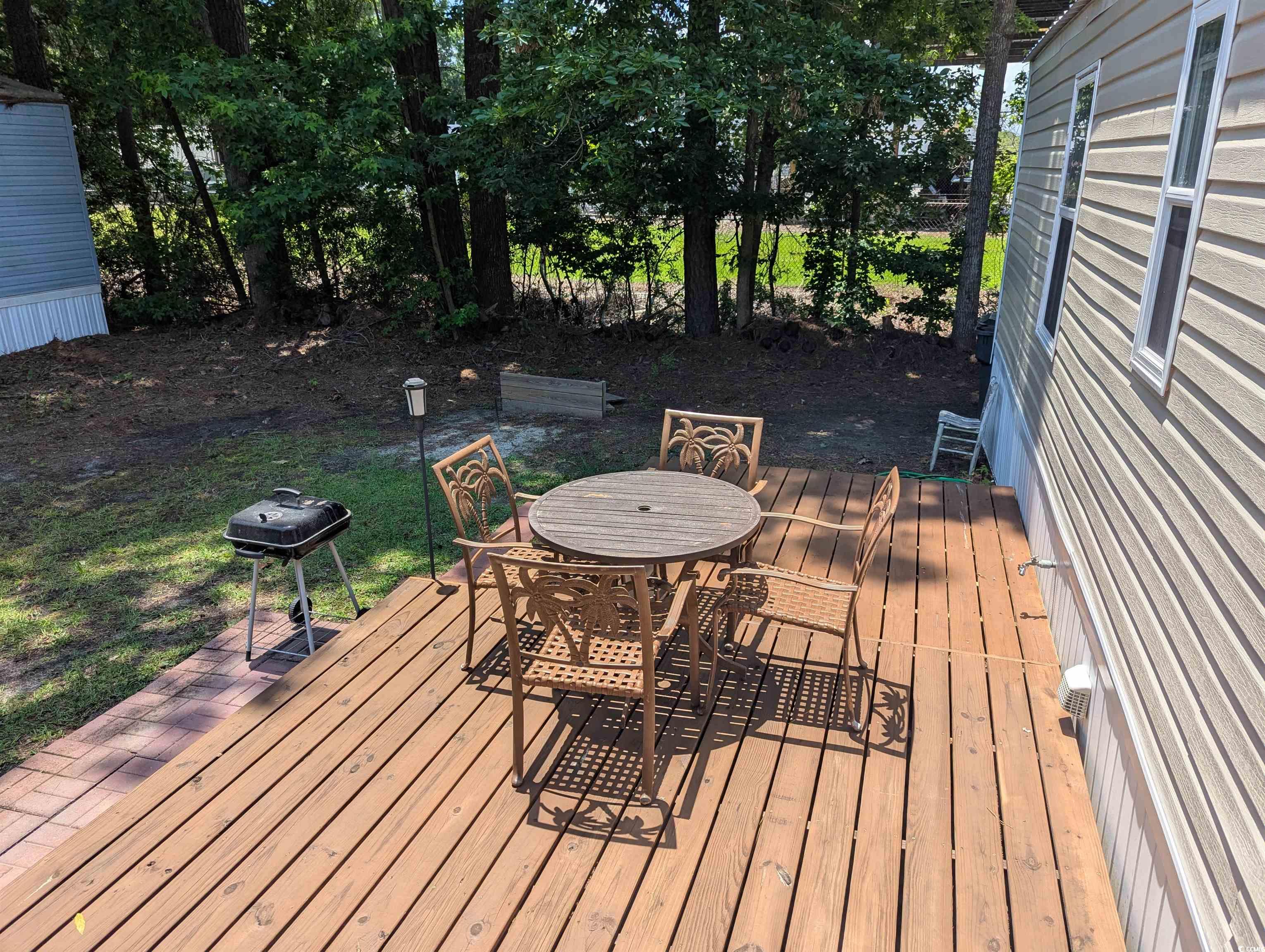 148 Offshore Drive Murrells Inlet, SC 29576 - Photo 15 of 18 Wooden deck featuring outdoor dining space and a grill
