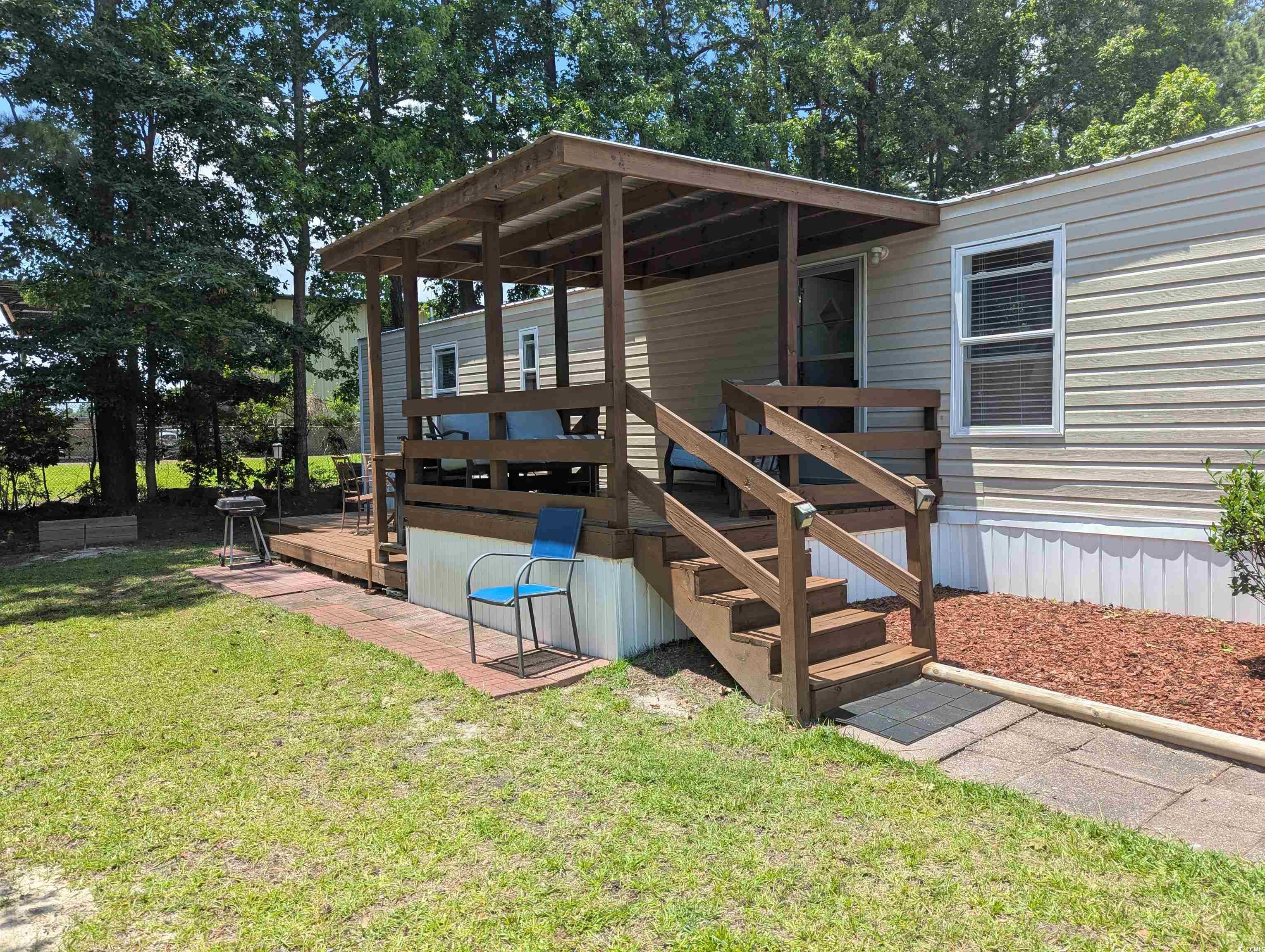 148 Offshore Drive Murrells Inlet, SC 29576 - Photo 17 of 18 Wooden terrace featuring a lawn