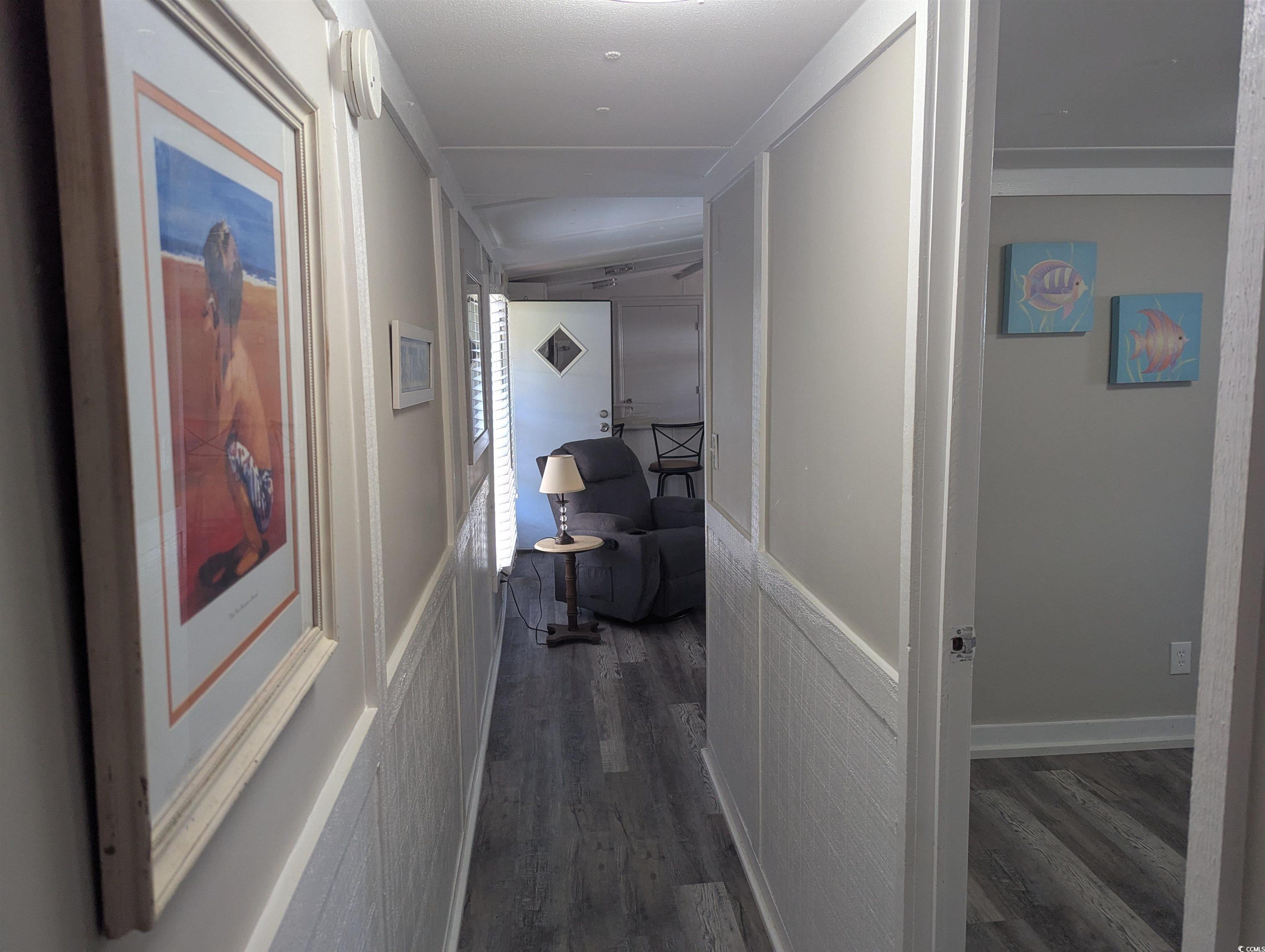 Hallway with dark wood finished floors