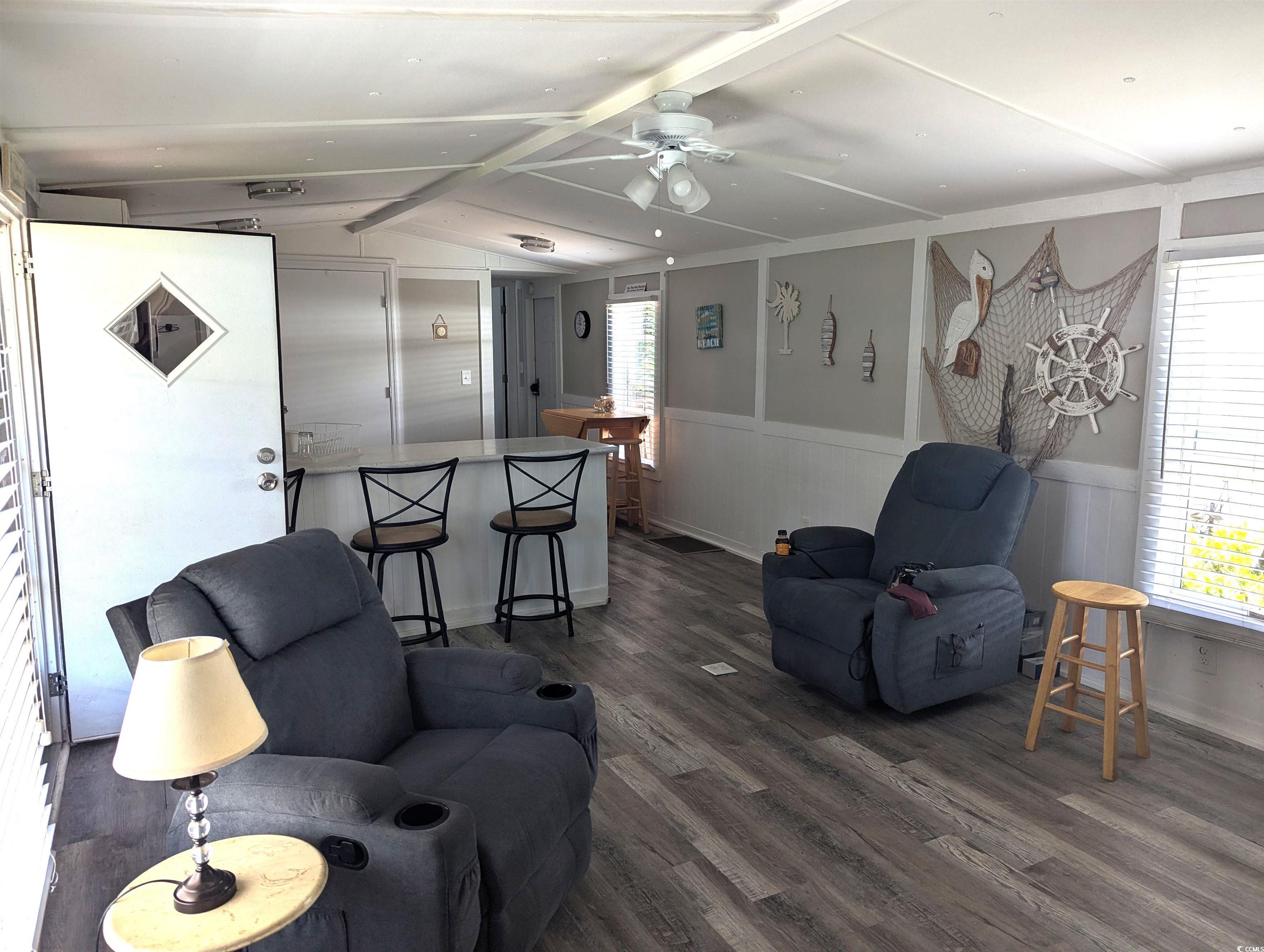 148 Offshore Drive Murrells Inlet, SC 29576 - Photo 8 of 18 Living room featuring dark wood-style flooring, a wainscoted wall, and ceiling fan