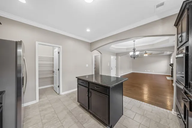 a kitchen with stainless steel appliances granite countertop a refrigerator and a sink