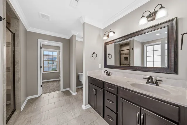 a spacious bathroom with a double vanity sink double and mirror