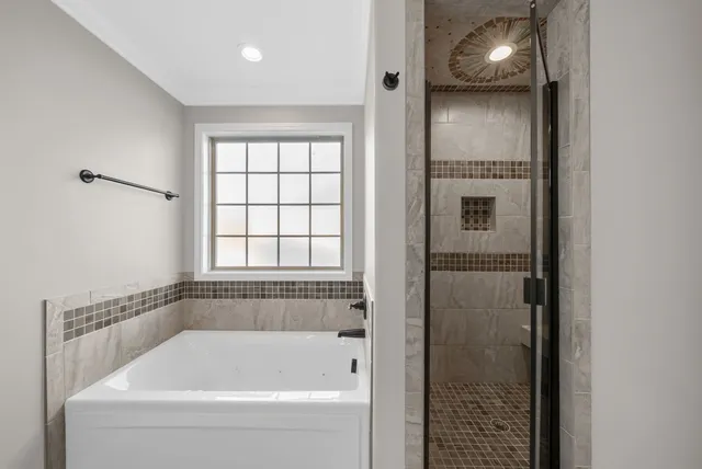 a white bath tub sitting next to a window